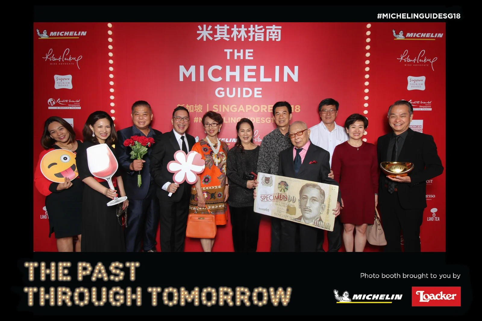 Guests at the Michelin Guide Singapore event in a red and black photo booth print