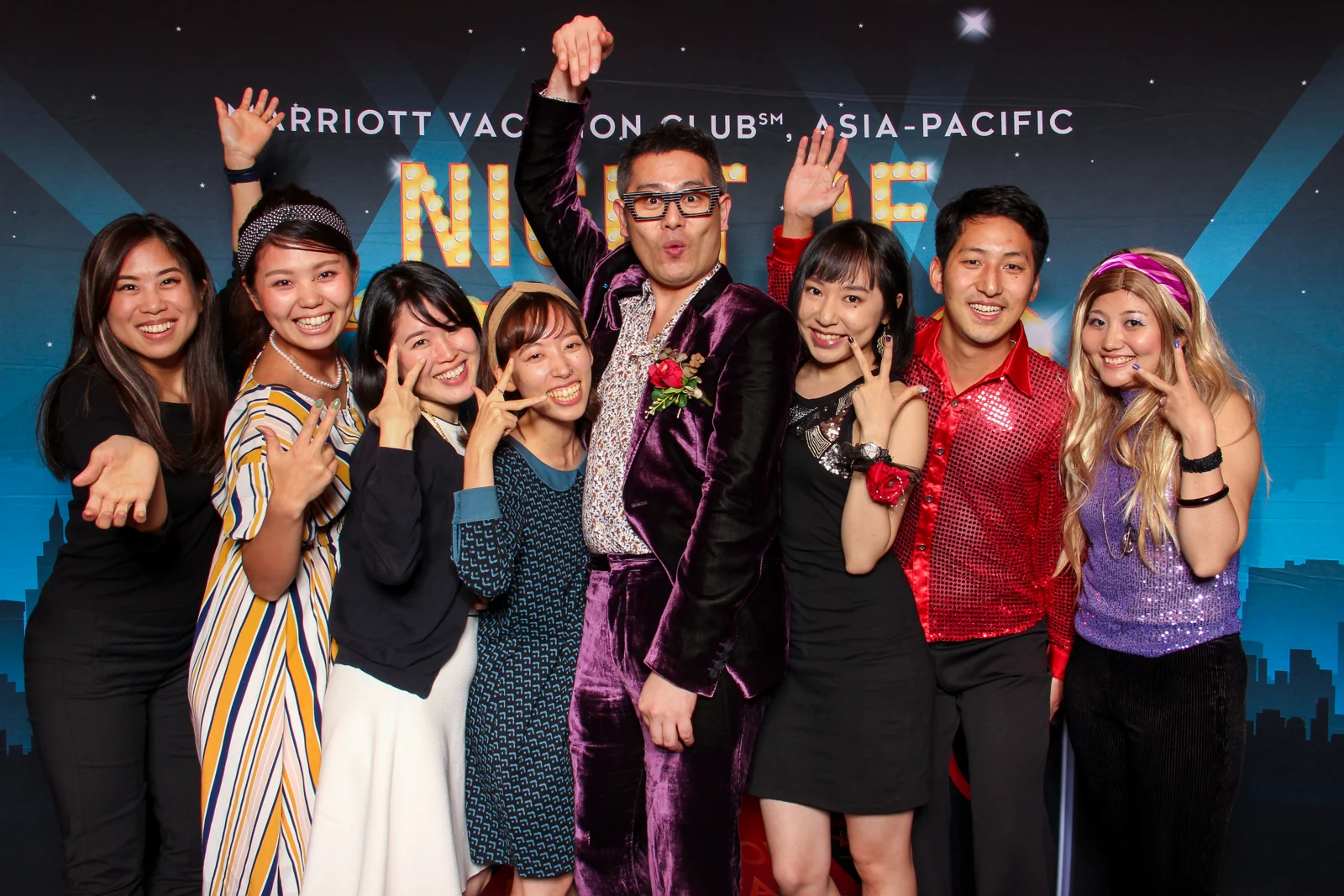 Corporate event guests dressed up and enjoying a Whoots photo booth