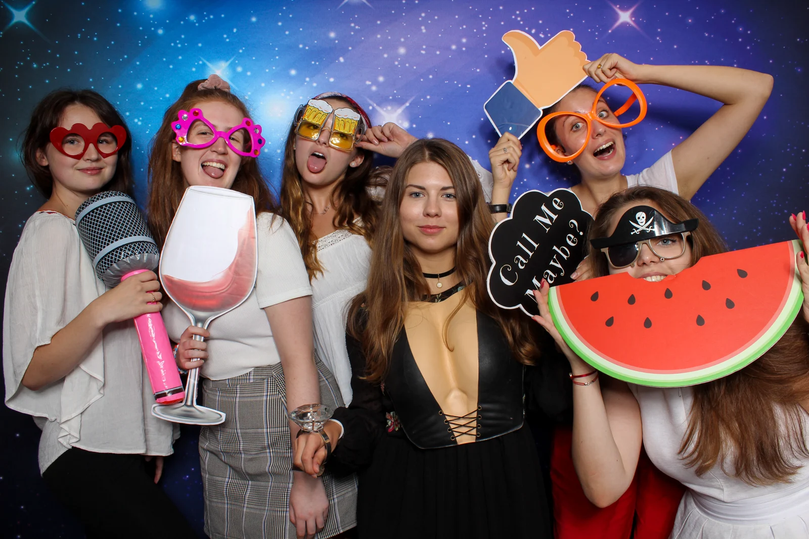 Friends enjoying colourful props at a Whoots event